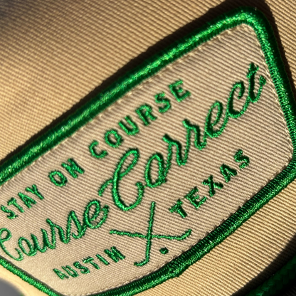 Embroidered patch with 'Stay on Course Correct, Austin, Texas' text on beige fabric.